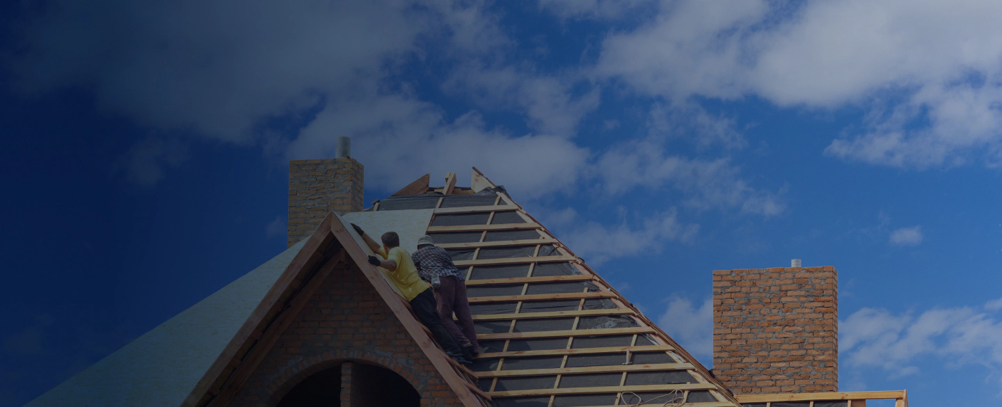 House under construction. Workesr installing fibreboard on the roof jackson st golden co